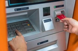 Customer withdrawing cash from ATM