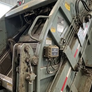 Monitoring device installed on waste compactor equipment.