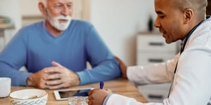 Doctor speaking with an older patient at home