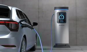 Electric vehicle charging at EV station with digital display.